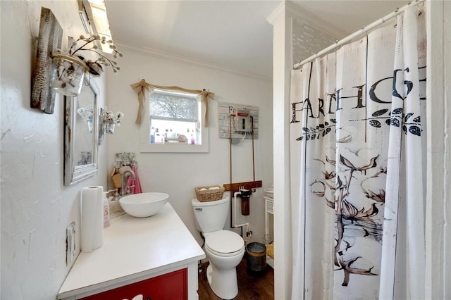 bathroom featuring wood-type flooring, vanity, toilet, and ornamental molding