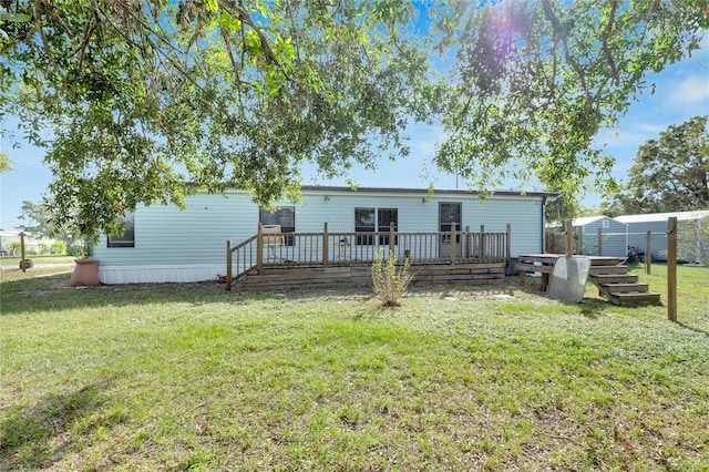 back of house featuring a yard and a deck