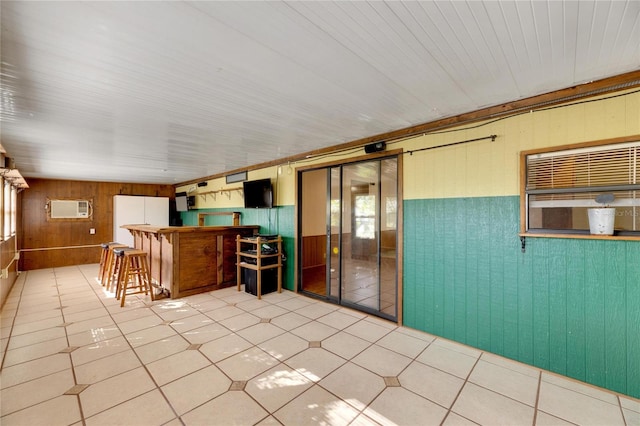 interior space with a wall mounted AC and indoor bar