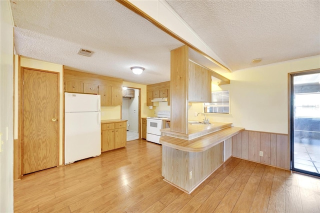 kitchen featuring kitchen peninsula, light brown cabinets, white appliances, and light hardwood / wood-style floors