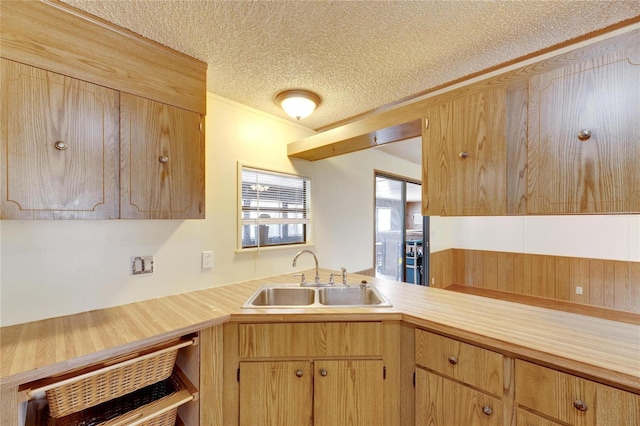 kitchen featuring a textured ceiling and sink