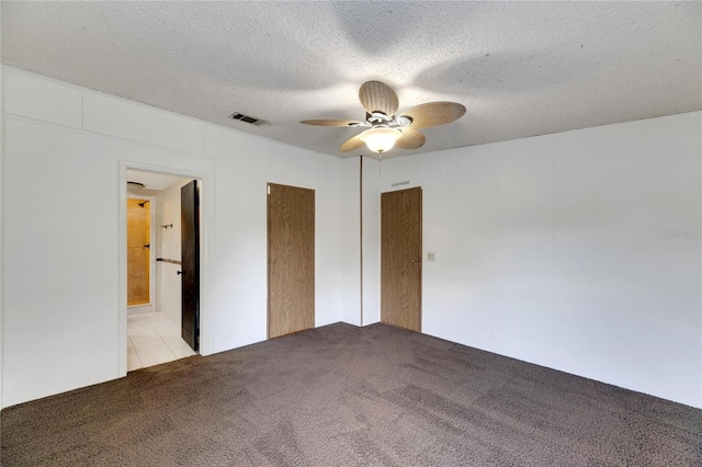 interior space with ceiling fan, light colored carpet, and a textured ceiling