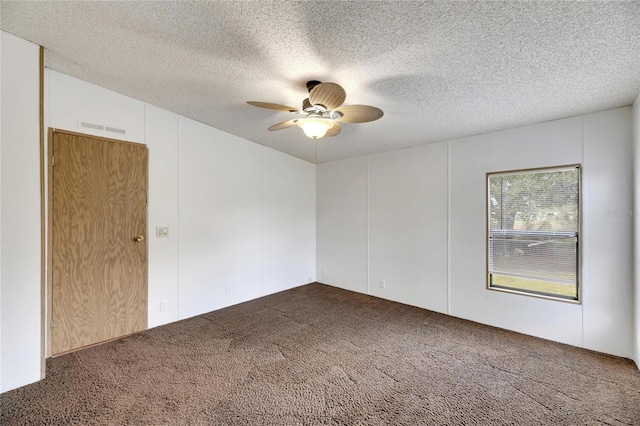 carpeted spare room with a textured ceiling and ceiling fan