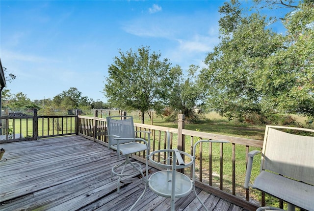 wooden terrace featuring a yard