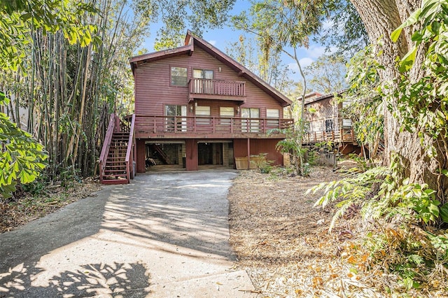 view of property with a wooden deck and a balcony