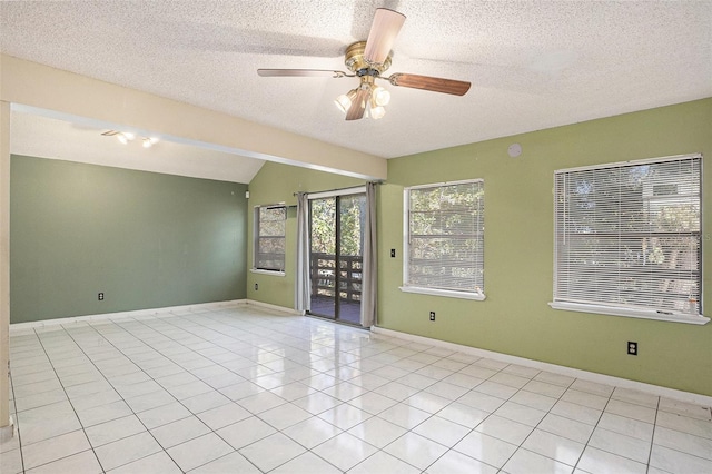 unfurnished room with light tile patterned floors and a textured ceiling