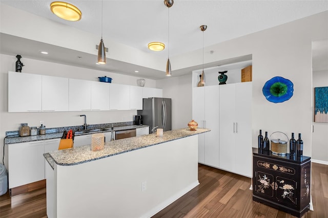 226 5th Ave N Unit 706, Saint Petersburg, FL 33701 - kitchen with a sink, white cabinets, hanging light fixtures, dark wood finished floors, and appliances with stainless steel finishes