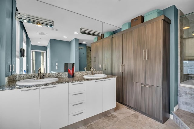 226 5th Ave N Unit 706, Saint Petersburg, FL 33701 - bathroom with double vanity, visible vents, walk in shower, and a sink