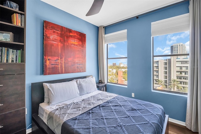 226 5th Ave N Unit 706, Saint Petersburg, FL 33701 - bedroom featuring baseboards, a ceiling fan, and wood finished floors