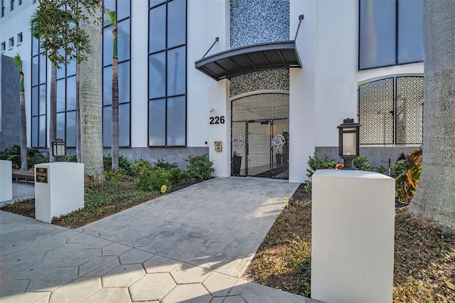 entrance to property with stucco siding