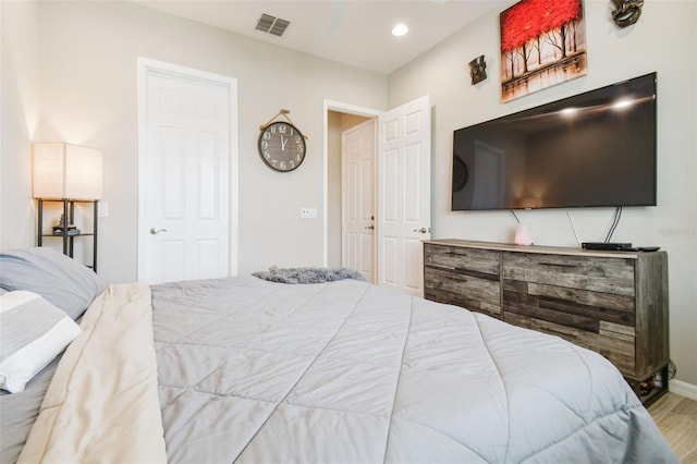 bedroom with hardwood / wood-style flooring