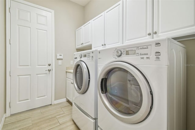 laundry room with cabinets and washing machine and dryer