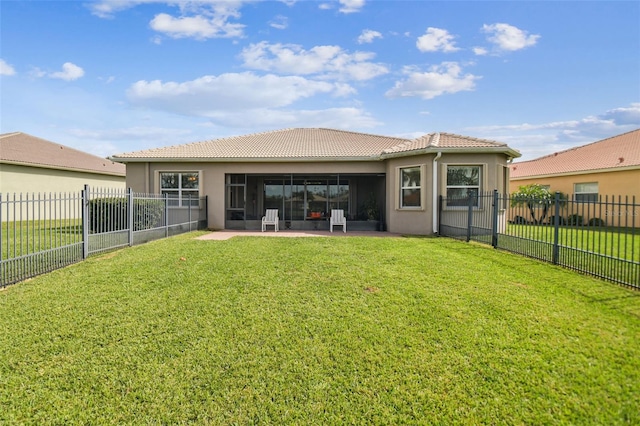 rear view of property featuring a yard and a patio