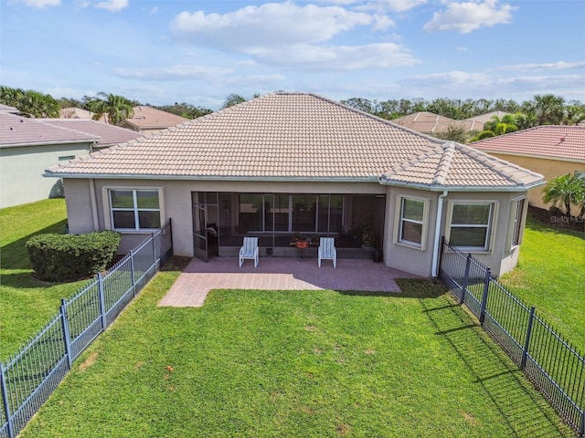 rear view of house with a yard and a patio