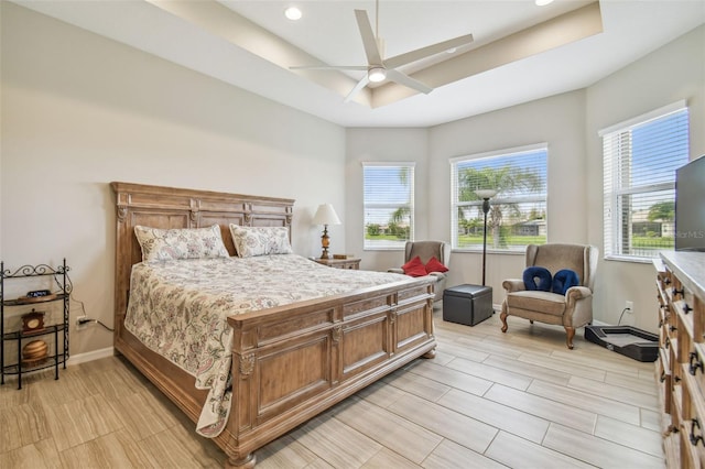 bedroom featuring ceiling fan and a raised ceiling