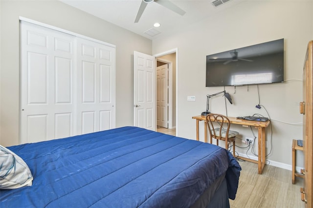 bedroom featuring light wood-type flooring, a closet, and ceiling fan