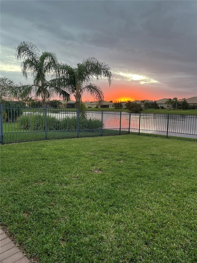 yard at dusk with a water view