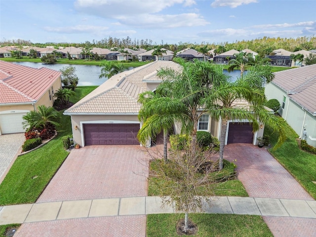 view of front of property featuring a water view and a garage