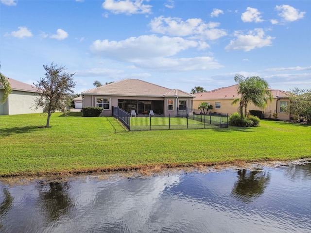 back of property featuring a yard and a water view