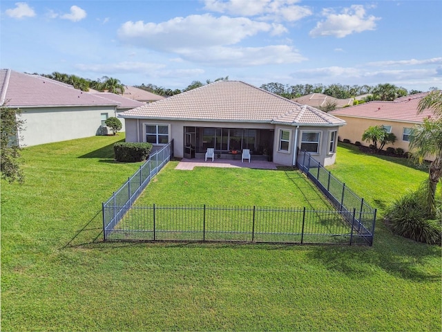 rear view of property featuring a patio area and a lawn