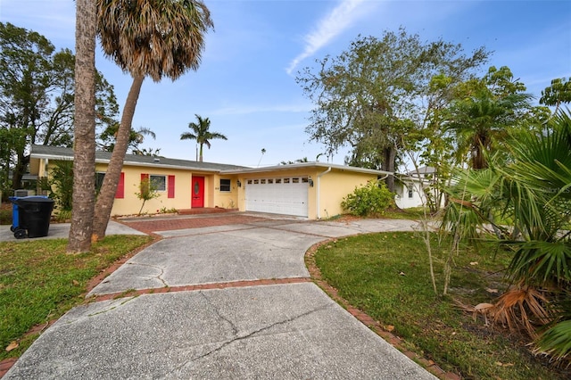 single story home with a front yard and a garage