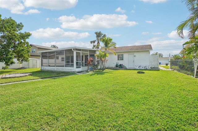 rear view of property with a lawn