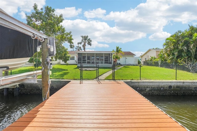 dock area featuring a water view and a yard