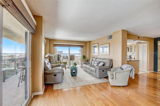 1651 Sand Key Estates Ct Unit 52, Clearwater, FL 33767 - living area with a textured ceiling, hardwood / wood-style floors, and baseboards