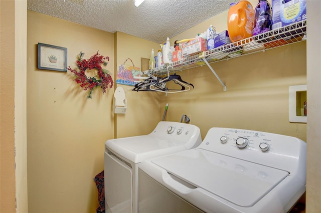 laundry room with separate washer and dryer and a textured ceiling