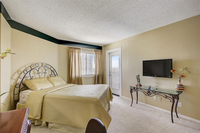 bedroom with a textured ceiling and light carpet