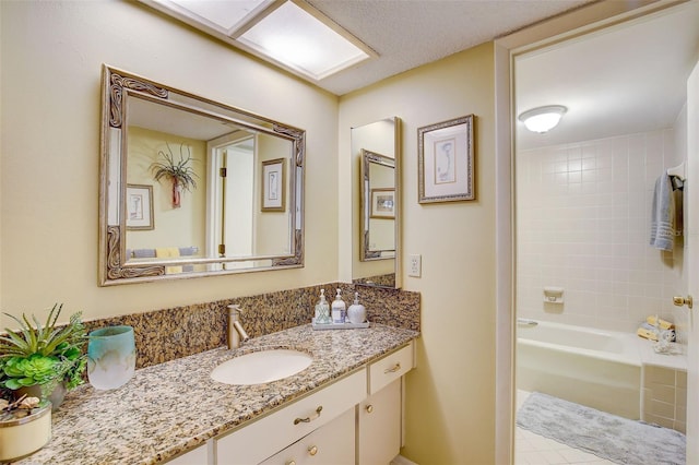 bathroom featuring vanity and tiled shower / bath combo