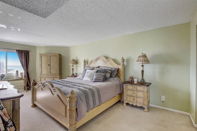 carpeted bedroom featuring a textured ceiling