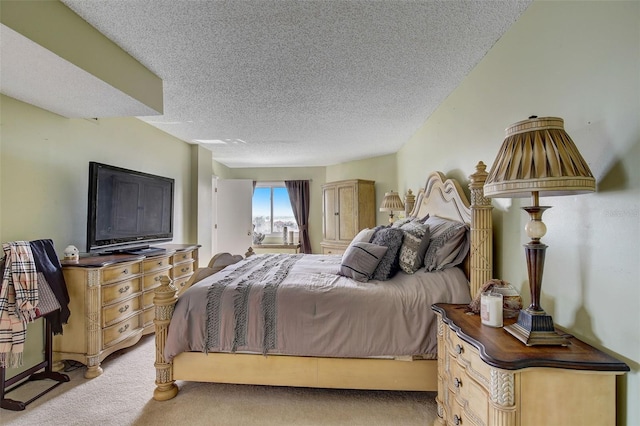 bedroom with a textured ceiling and light colored carpet