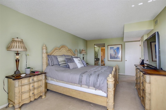 bedroom with carpet floors and a textured ceiling