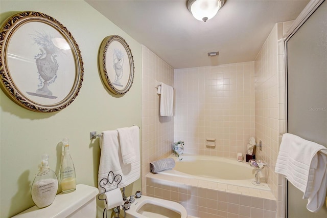 bathroom featuring toilet, shower with separate bathtub, and a bidet