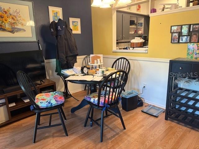 2100 World Parkway Blvd Unit 14, Clearwater, FL 33763 - dining area featuring wood finished floors, an office area, and a wainscoted wall