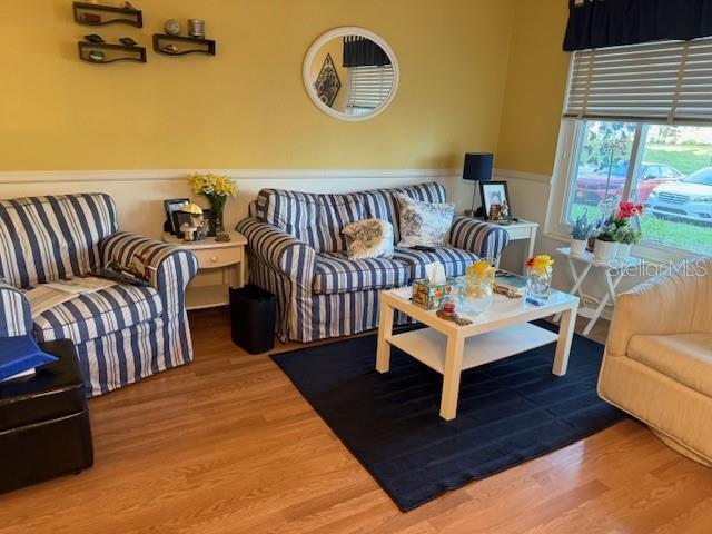 2100 World Parkway Blvd Unit 14, Clearwater, FL 33763 - living room featuring wood finished floors and wainscoting