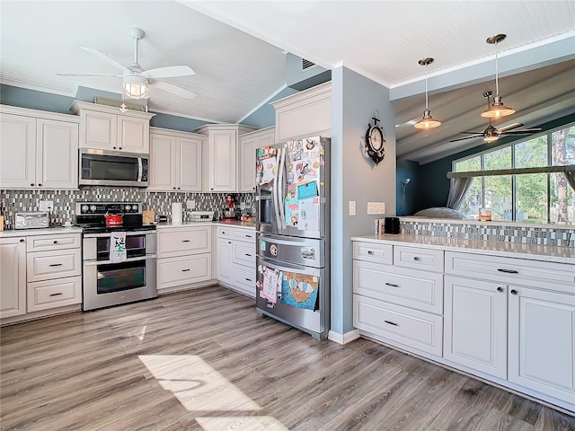 kitchen featuring tasteful backsplash, stainless steel appliances, ceiling fan, and lofted ceiling