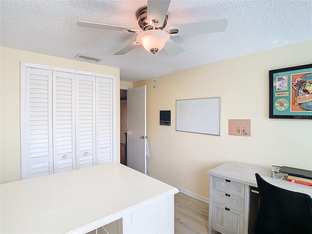 office featuring light hardwood / wood-style floors and a textured ceiling