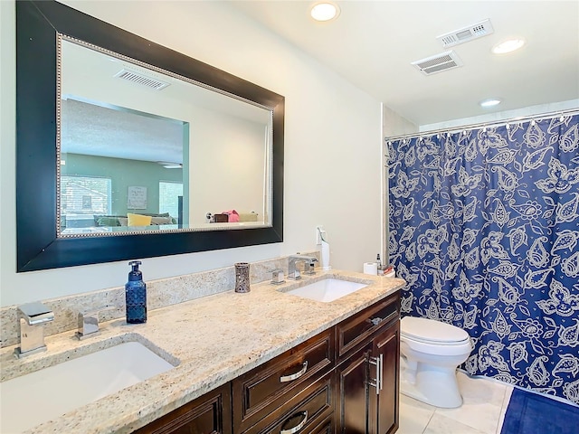 bathroom featuring tile patterned flooring, vanity, and toilet