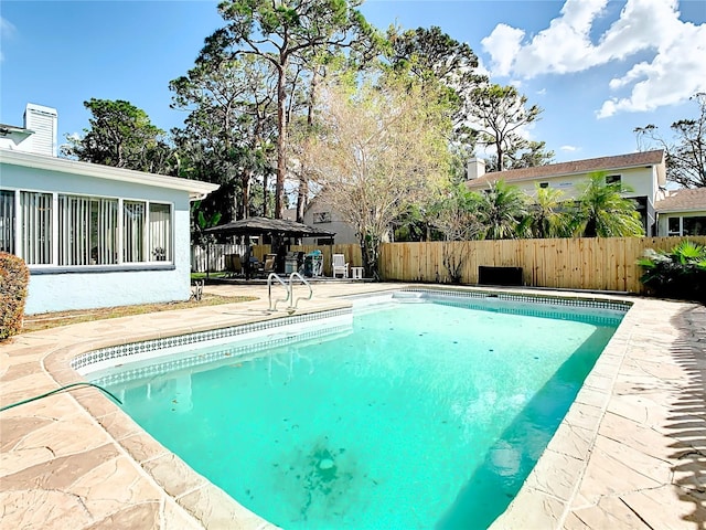 view of swimming pool with a gazebo and a patio area