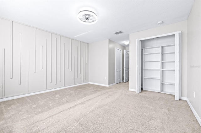 unfurnished bedroom featuring light carpet