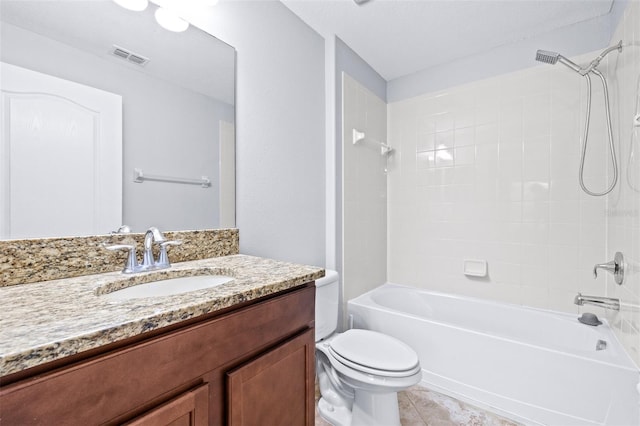 full bathroom featuring tile patterned flooring, vanity, toilet, and tiled shower / bath