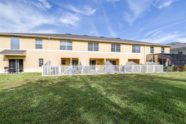 rear view of property featuring a yard