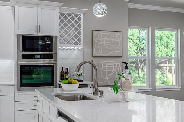 3845 Seena Manor Ct, Tampa, FL 33618 - kitchen with stainless steel oven, a sink, ornamental molding, built in microwave, and light stone counters