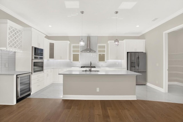 kitchen featuring wine cooler, wall chimney range hood, appliances with stainless steel finishes, and backsplash