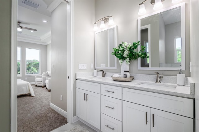 bathroom featuring ornamental molding, vanity, and ceiling fan