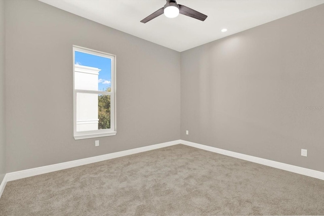 carpeted empty room with ceiling fan