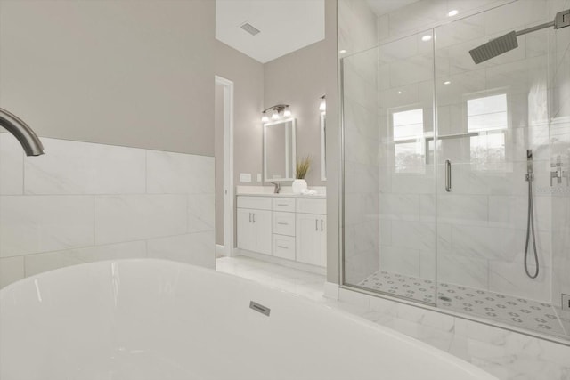 3845 Seena Manor Ct, Tampa, FL 33618 - bathroom with a freestanding tub, a stall shower, vanity, and marble finish flooring