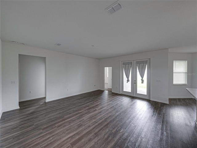 232 Samantha Ave, Auburndale, FL 33823 - unfurnished living room with french doors, dark wood-type flooring, and baseboards